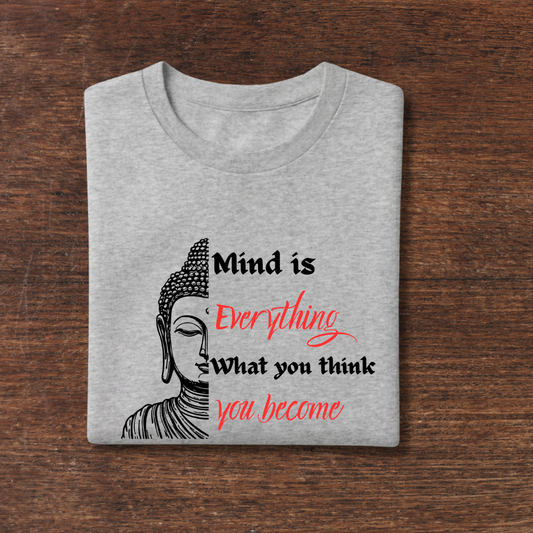 Gray t-shirt with Buddha graphic and motivational quote on a wooden surface