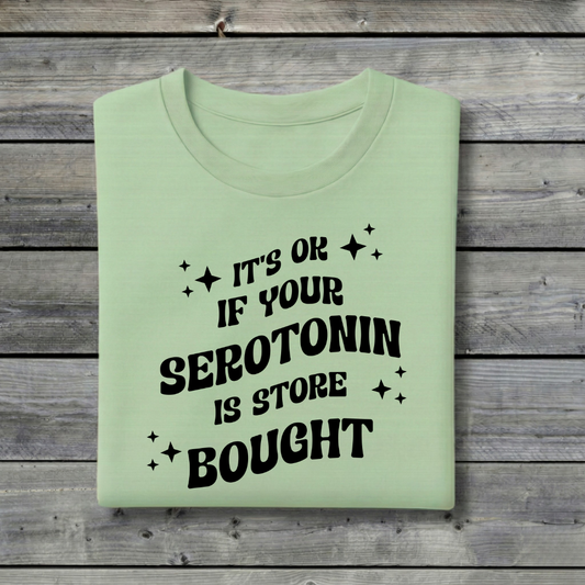 Light green t-shirt with black text on a wooden background