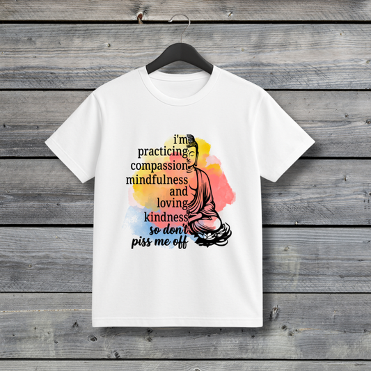 White t-shirt with a colorful design and text on a wooden background