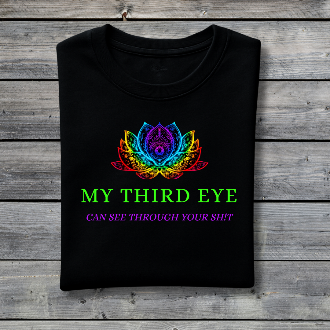 Black t-shirt with colorful lotus design and text on a wooden surface
