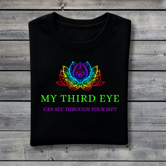 Black t-shirt with colorful lotus design and text on a wooden surface