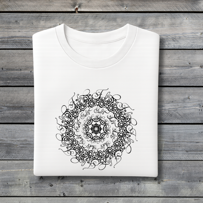 White t-shirt with black intricate design on a wooden surface