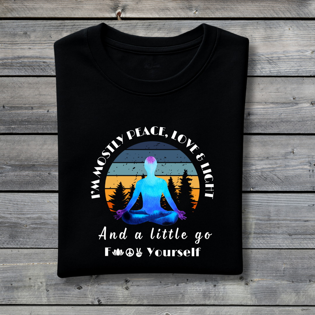 Black t-shirt with a graphic of a person meditating and text on a wooden background