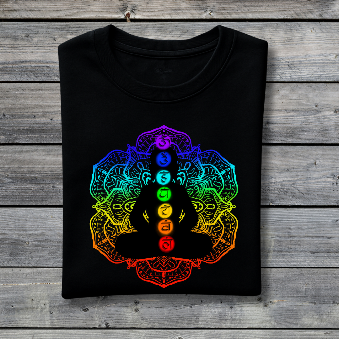 Black t-shirt with a colorful chakra design on a wooden surface