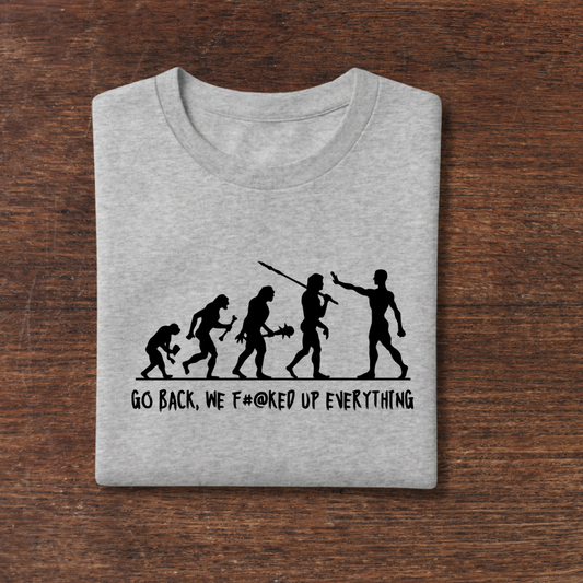 Gray t-shirt with black graphic and text on a wooden surface