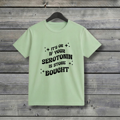 Light green t-shirt with black text on a wooden background