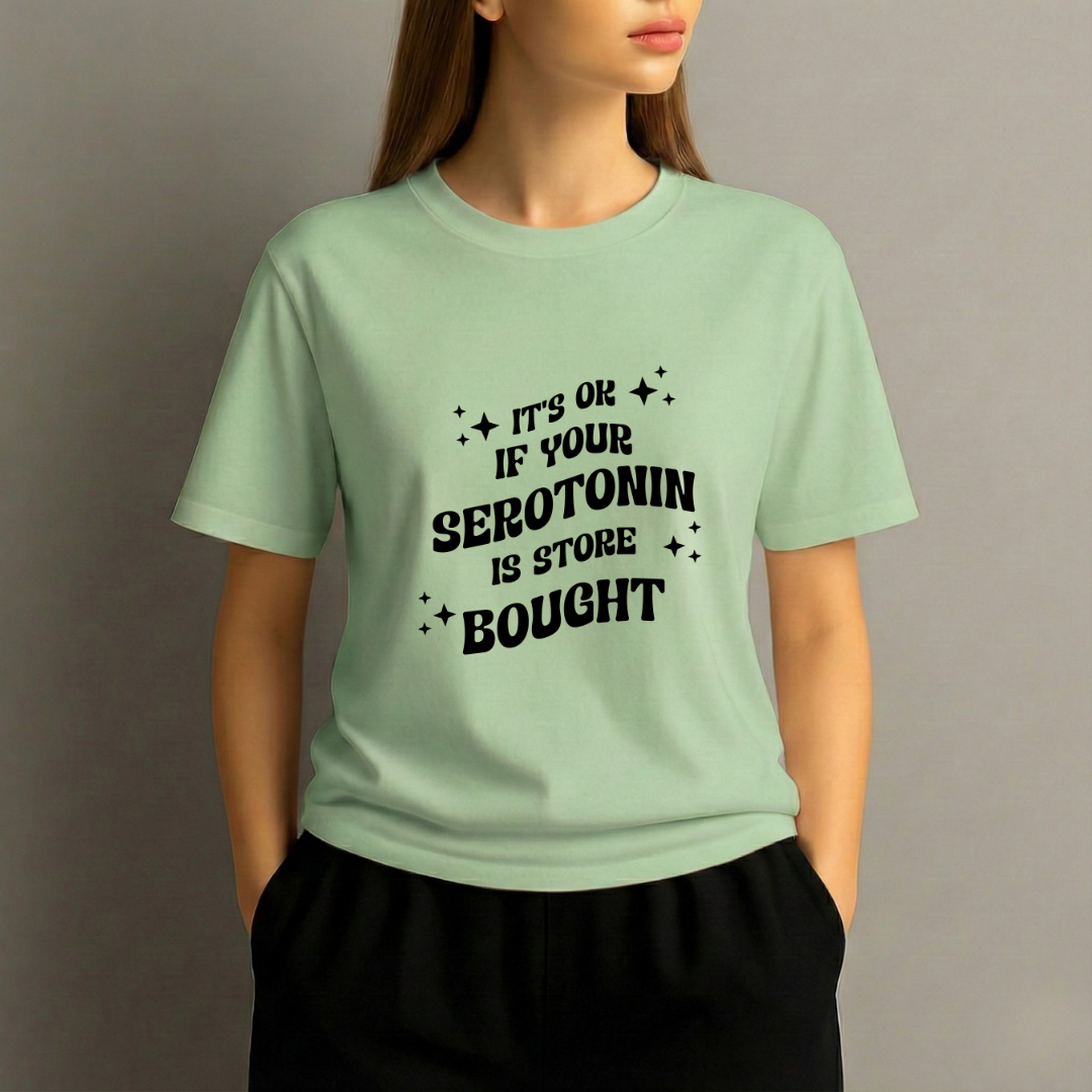 Person wearing a light green t-shirt with black text on a plain background